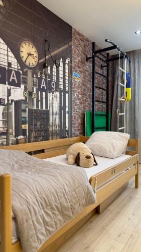 a bedroom with a bed with a stuffed animal on it at Premium apartment in Ternopilʼ