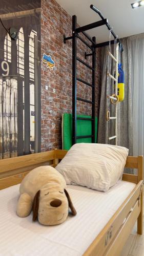 a stuffed dog head laying on a bed at Premium apartment in Ternopilʼ