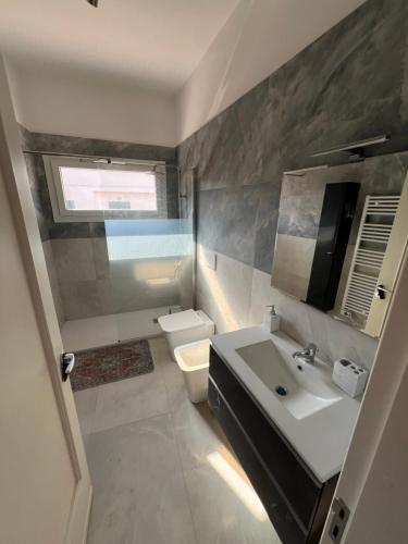 a bathroom with a sink and a toilet at Casa GIOSA in Baia Verde