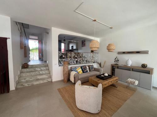 a living room with a couch and a table at Casa GIOSA in Baia Verde