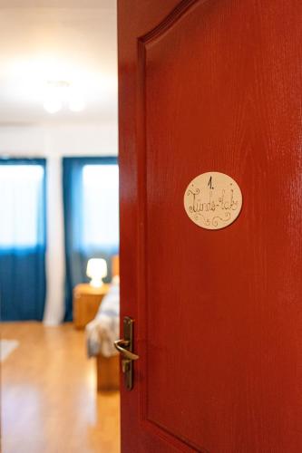 a red door with a sticker on it at Dósa tanya, Vendégház in Cserépfalu