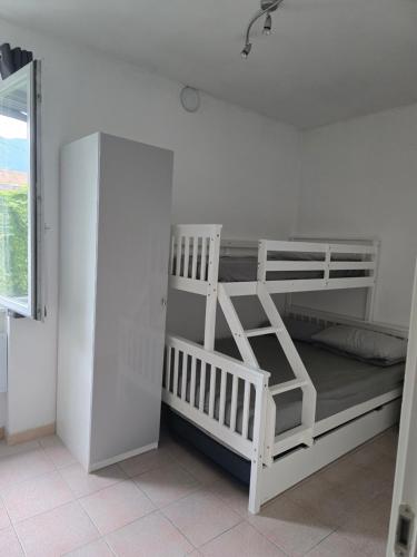 a white bunk bed in a white room at La Casetta al Lago in Sorico