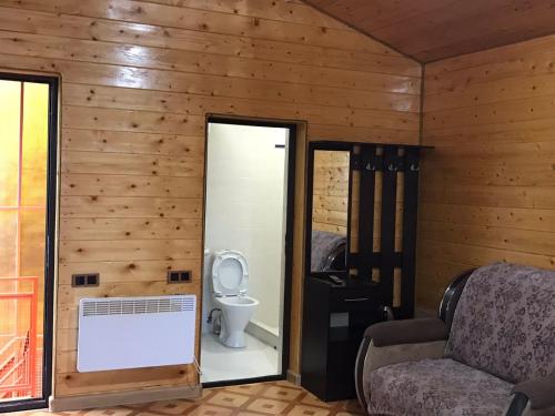 a room with a bathroom with a toilet and a chair at Syuzn Resort in Goris