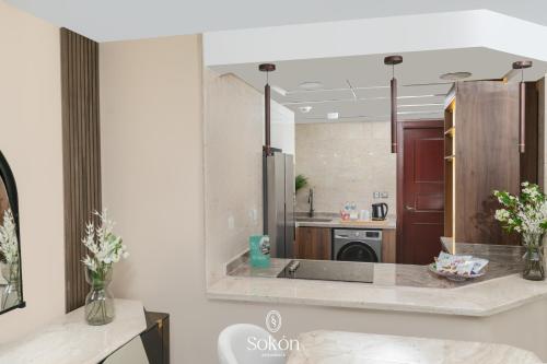 a kitchen with a large mirror on the wall at Sokon Residence Partial Nile view at Maadi in Cairo
