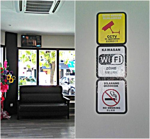 two pictures of signs on a wall in a living room at Grand Kapar Hotel Kuala Selangor in Kuala Selangor
