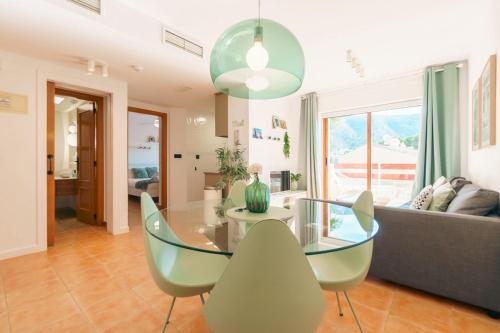 a dining room with a glass table and chairs at Renteando Albir Apartments in Albir