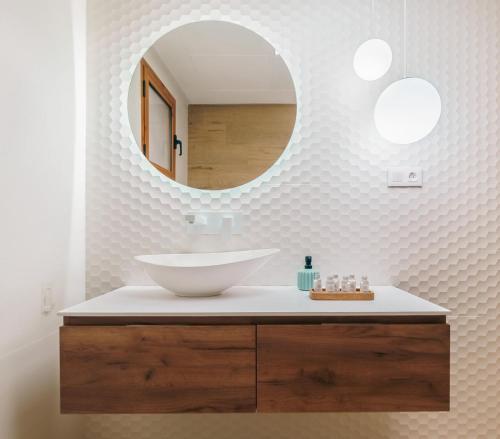 a bathroom with a sink and a mirror at Renteando Albir Apartments in Albir