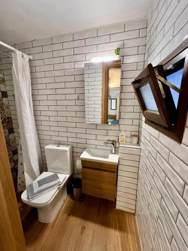 a bathroom with a toilet and a sink at Blue City Studio in Kavála