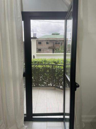 a door to a balcony with a view of a building at Kemadjou Boutique Stay in Yaoundé