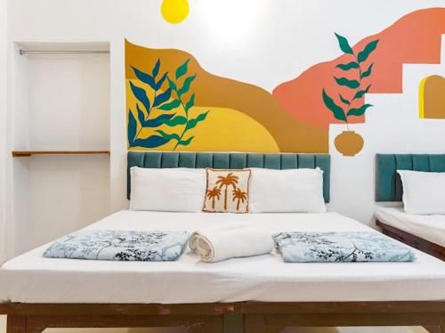 a bed with two pillows on it in a room at Raahee Homestay in Varanasi