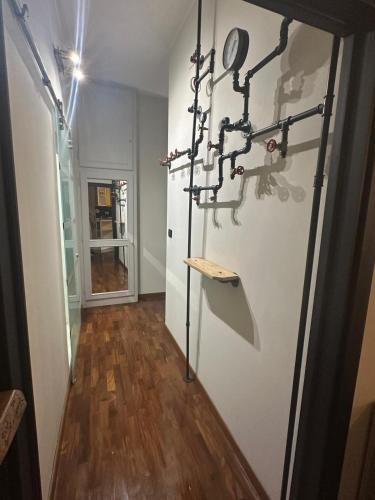 a hallway with a white refrigerator and a wooden floor at Casa Gianna in Corciano