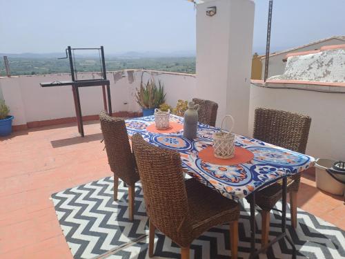 a table and chairs on a patio with a view at Apartamento Rural La Manchega in Villar del Arzobispo