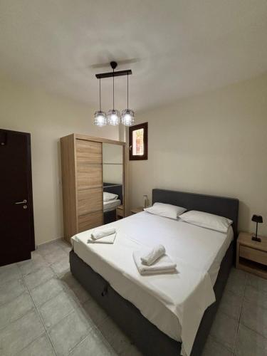 a bedroom with a large bed with two towels on it at Endless Blu Apartments in Pyrgadikia