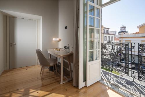 a room with a desk and a large window at Mercure Ponta Delgada Azores in Ponta Delgada