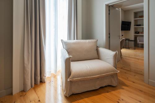 a chair sitting in front of a window at Mercure Ponta Delgada Azores in Ponta Delgada