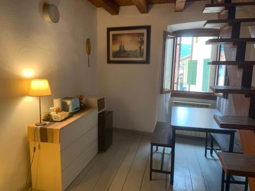 a room with a desk with a lamp and a window at Corte 40 Rooms in Negrar
