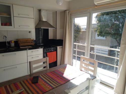 a kitchen with a table and a large window at San Benito Apart in Tandil