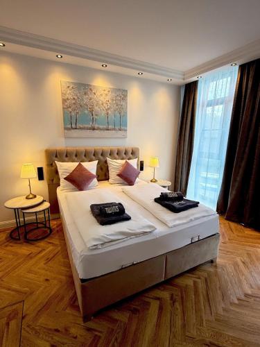 a large bed in a bedroom with a large window at Twins Hotel in Duisburg
