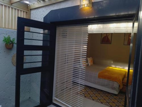 a room with a large window with a bed in it at 81 A & Away Studio apartment West Wing in Mossel Bay
