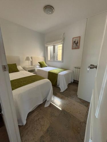 a bedroom with two beds and a window at Chancelas b in Combarro