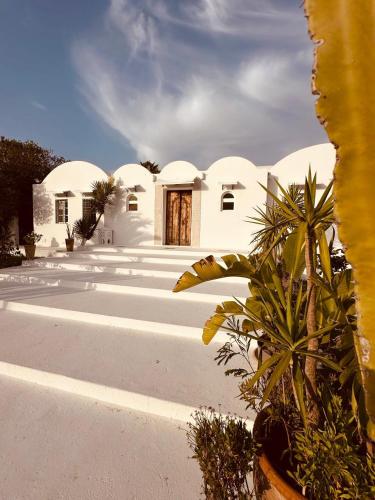 a white building with trees in front of it at Evasion champetre à El Monchar Hammamet in Hammamet
