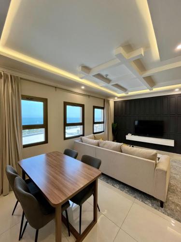 a living room with a couch and a table at لافانتا للشقق المخدومه - LAVANTA Hotel in Al Khobar