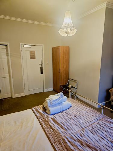 a bed with two white towels on it in a room at The Coach House in Otterburn