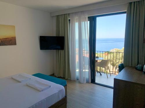a hotel room with a view of a balcony at REZEVICI BOUTIQUE VILLA in Petrovac na Moru