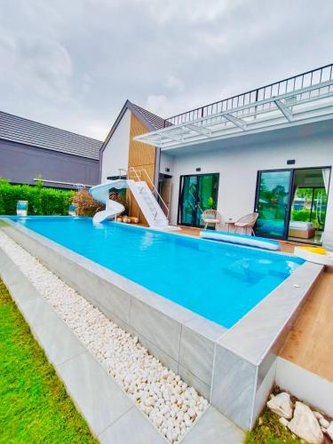 a swimming pool in the backyard of a house at Relax Pool Villa Khaoyai - รีแล็กซ์พูลวิลล่าเขาใหญ่ in Ban Bung Toei