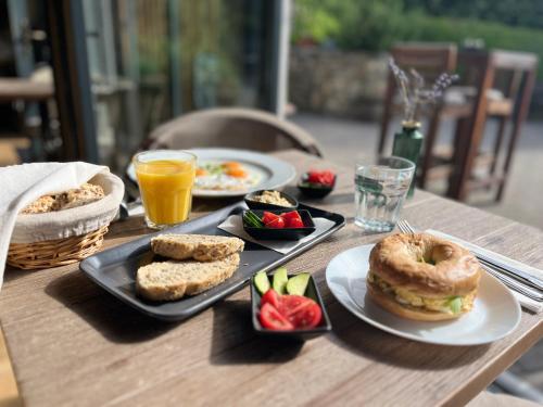 a table with plates of food and drinks on it at Hazai Provence in Kapolcs