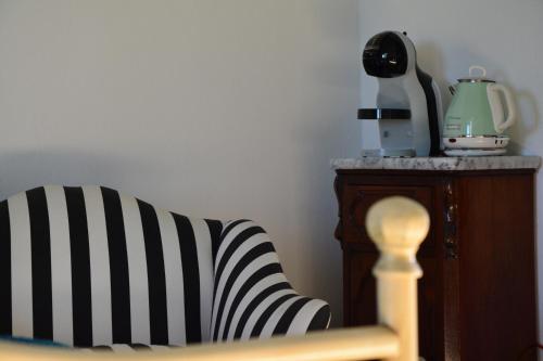 a black and white striped chair next to a table at Podere Campiano in Volterra
