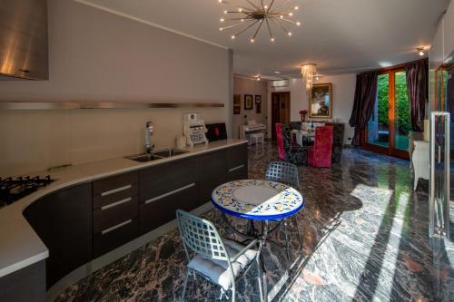 a kitchen with a table and chairs in a kitchen at Villa DAutore in Alba