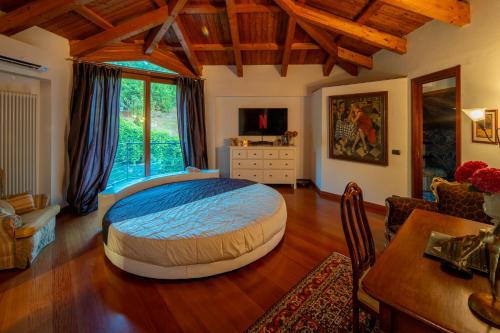 a bedroom with a large bed and a dining room at Villa DAutore in Alba