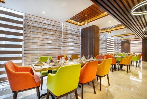 a restaurant with tables and chairs in a room at Royal Mark Hotel in Sylhet