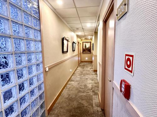 a hallway with blue glass bottles on the wall at Hostal Toledo in Toledo