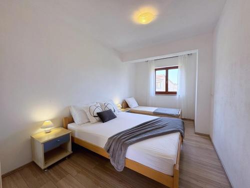 Postel nebo postele na pokoji v ubytování Apartment Dunato I