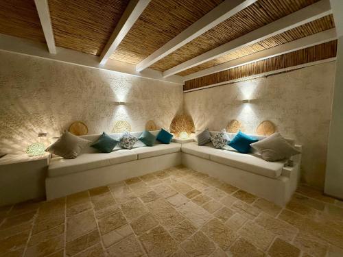 a living room with couches and pillows at Villa Malibu' a 50 mt dal mare in Campomarino