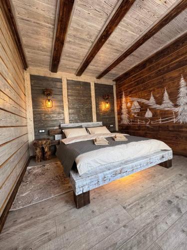a bedroom with a bed in a room with wooden walls at Zrub House in Slavske
