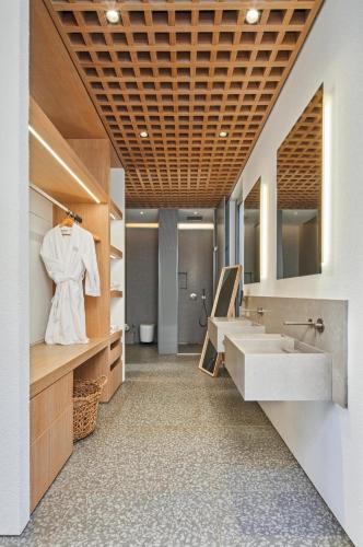 a bathroom with two sinks and a mirror at Voyage Torba Hotel in Torba