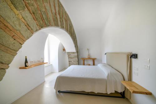 a bedroom with a bed and a brick wall at Tenuta Calitto wine resort e spa in Forio d'Ischia