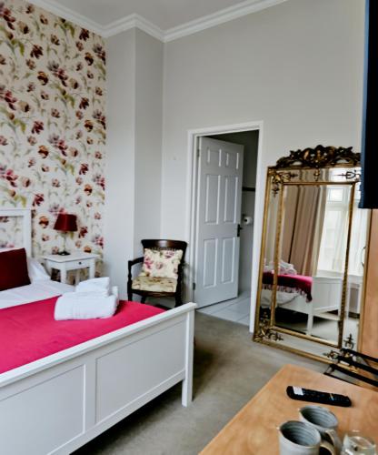 a bedroom with a bed and a mirror at The Coach House in Otterburn