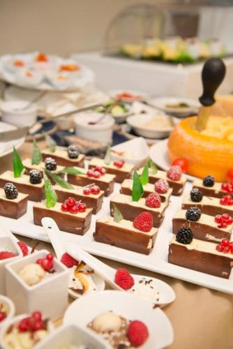 a bunch of desserts on plates on a table at Hotel Fiamma & SPA Cesenatico in Cesenatico