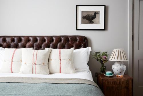 a bedroom with a large bed with white pillows at Artist Residence London in London