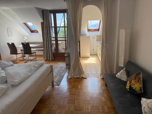 a living room with a couch and a table at Hotel ChiemseePanorama in Gstadt am Chiemsee