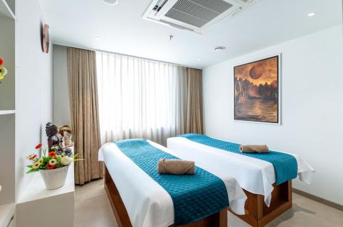 a hotel room with two beds and a window at The Paradise Bliss - A Luxury Hotel & Spa in Udaipur in Udaipur