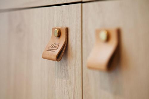a pair of wooden knobs on a wooden cabinet at Hampton By Hilton Stuttgart Airport in Filderstadt