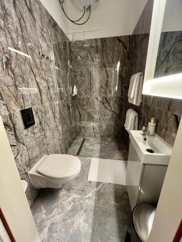 a bathroom with a toilet and a sink at RUMIDO Station in Valmiera