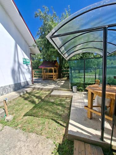 a patio with a wooden picnic table and a fence at Altan's Gold in Hangul