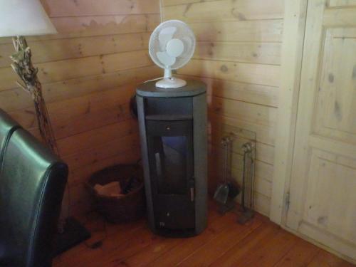 a room with a fan on top of a fireplace at Huis H8 in Epe