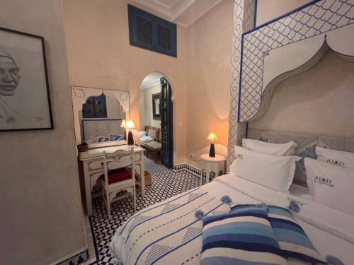 a bedroom with a large bed and a mirror at Riad Al-Qurtubi in Tangier